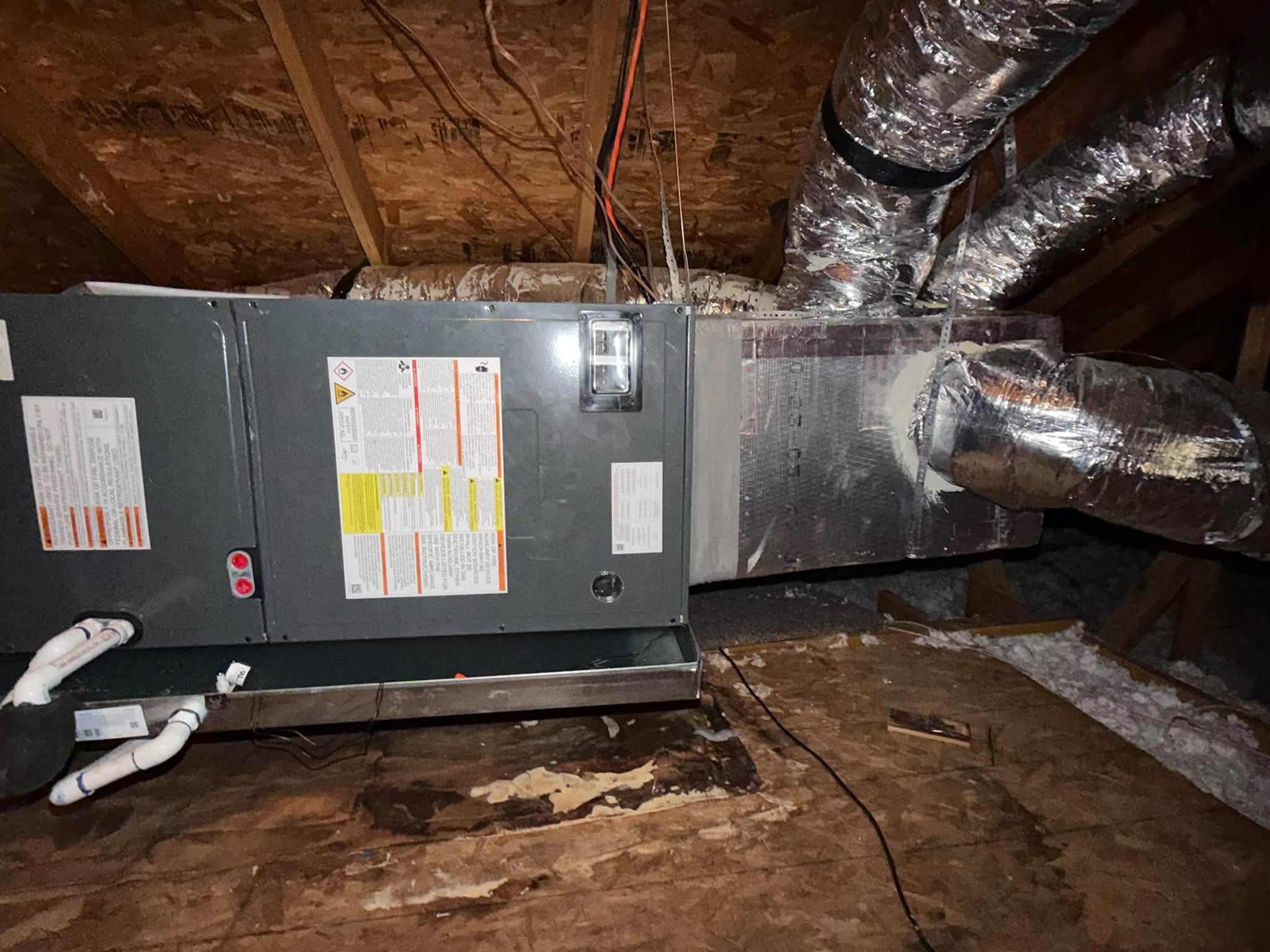 Air handler connected to insulated ductwork in an attic